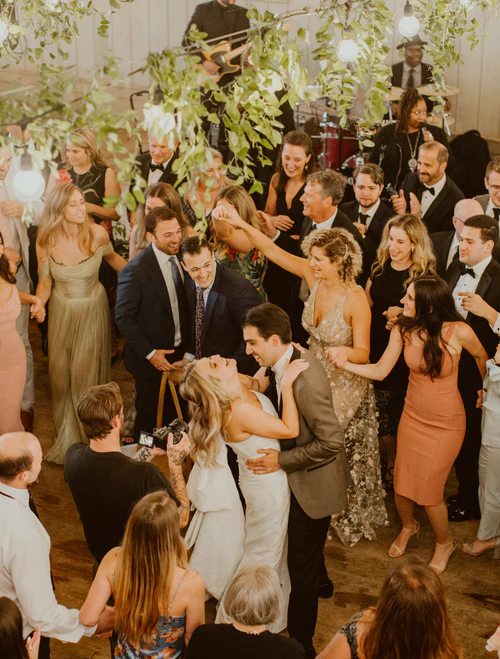 a bride and groom's first dance surrounded by people RG|NY